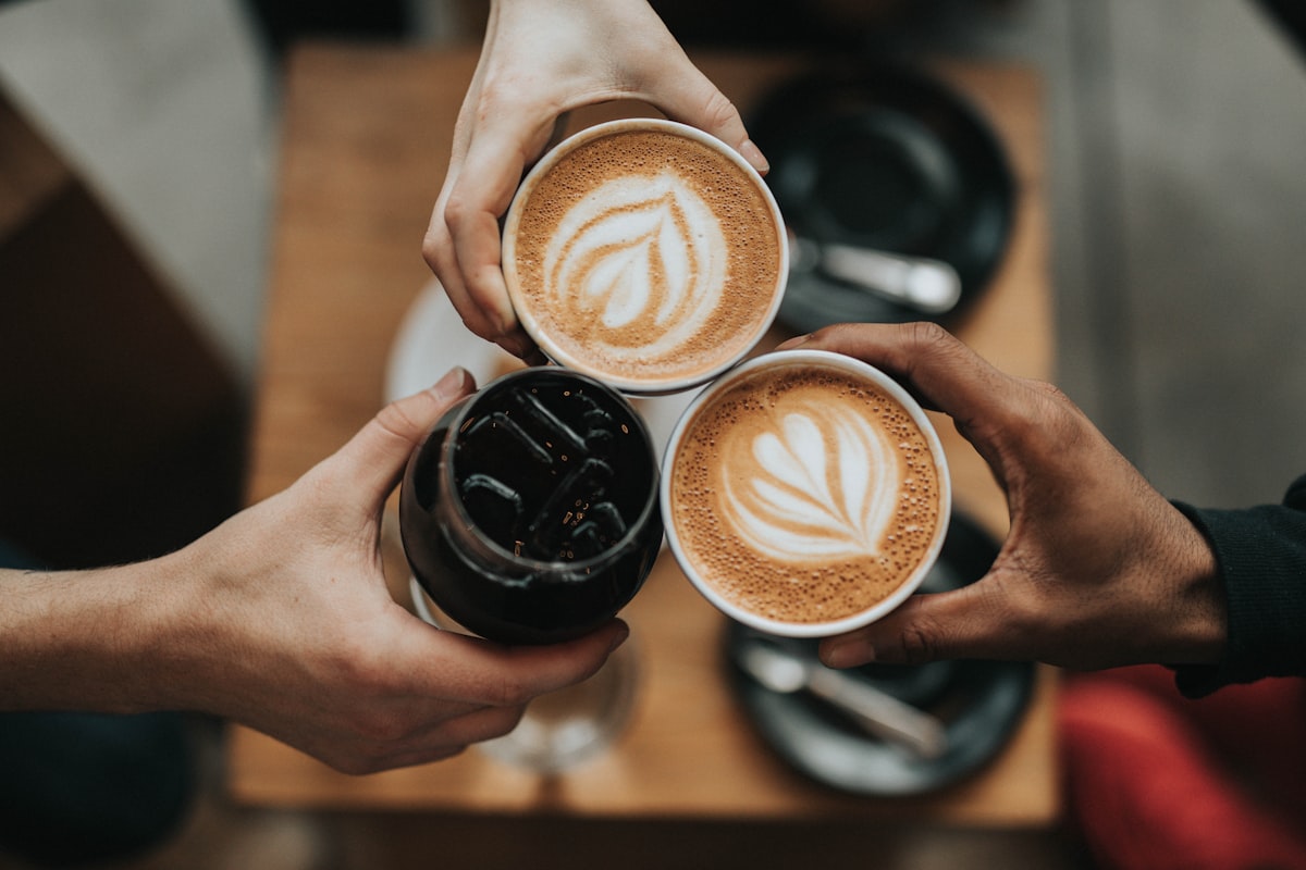 Overhead view of ceramic coffee cups on a wooden table